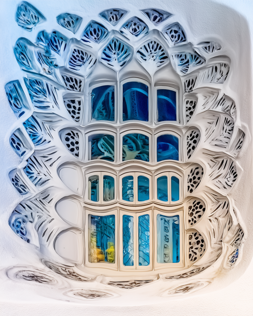 Intricate ceiling design featuring a large, stylized window with blue stained glass, surrounded by elaborate white organic patterns.