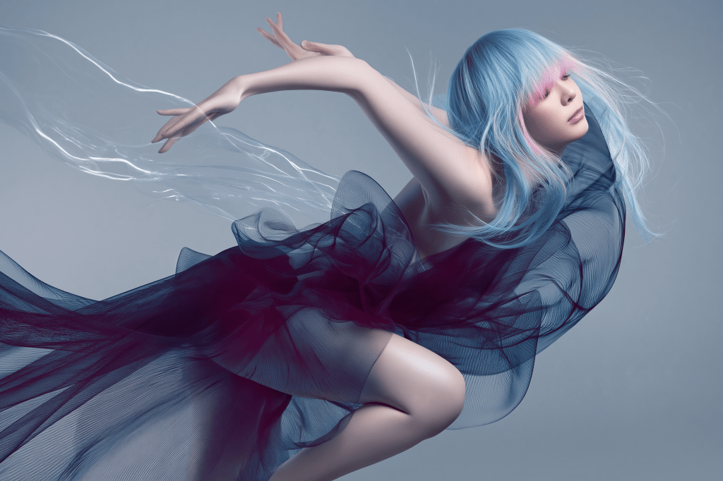 A dancer in an ethereal pose wearing flowing translucent fabric, with pastel blue hair styled elegantly.