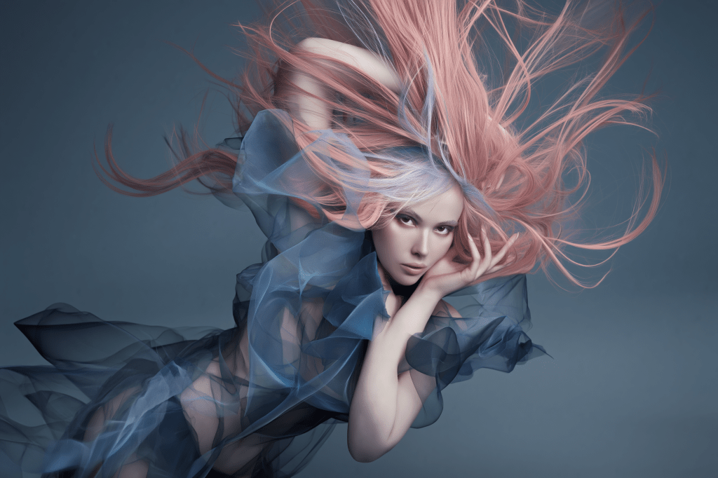 A model with long, flowing pink and light blue hair poses dramatically against a soft blue background, wearing a sheer, flowing garment that adds to the ethereal quality of the image.