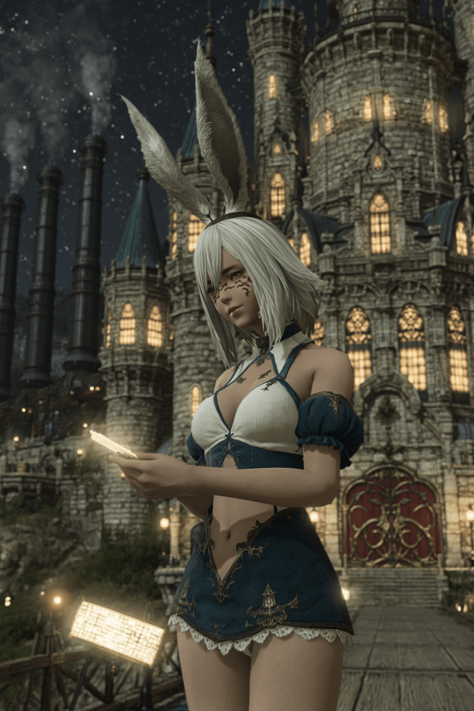 A fantasy character with white hair and bunny ears, dressed in a blue outfit, holding a lighted parchment in front of a grand castle at night.