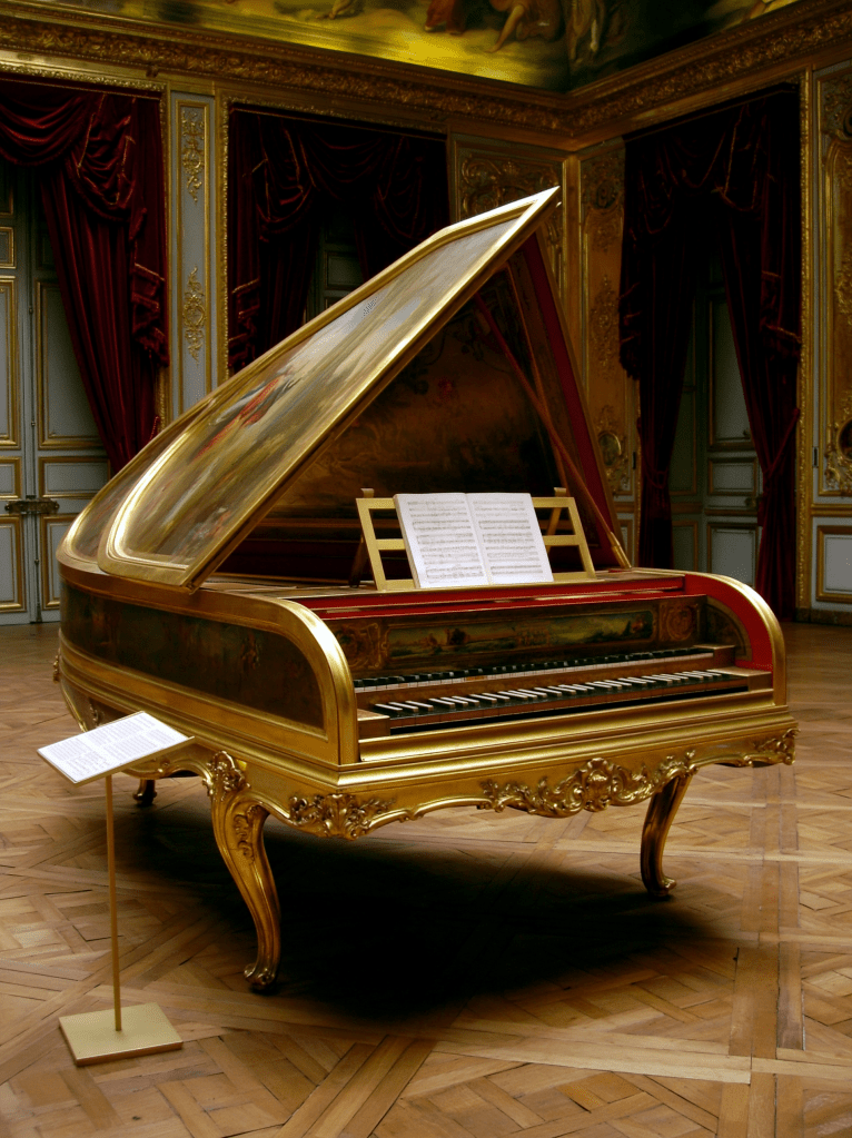 An ornate grand piano with a gold exterior, partially opened to reveal its keys and music sheets, situated in a lavishly decorated room with red drapes and intricate ceiling artwork.